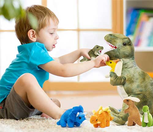 Child Playing with Plush Baby Dinosaurs